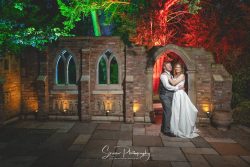 nailcote hall solihull wedding photography bride groom creative photo with coloured gels outside old monument